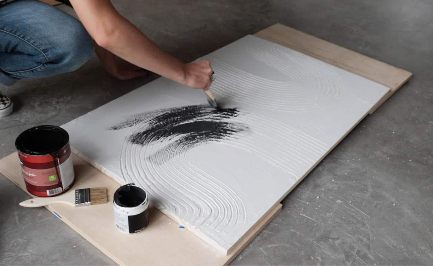 A person painting the design.