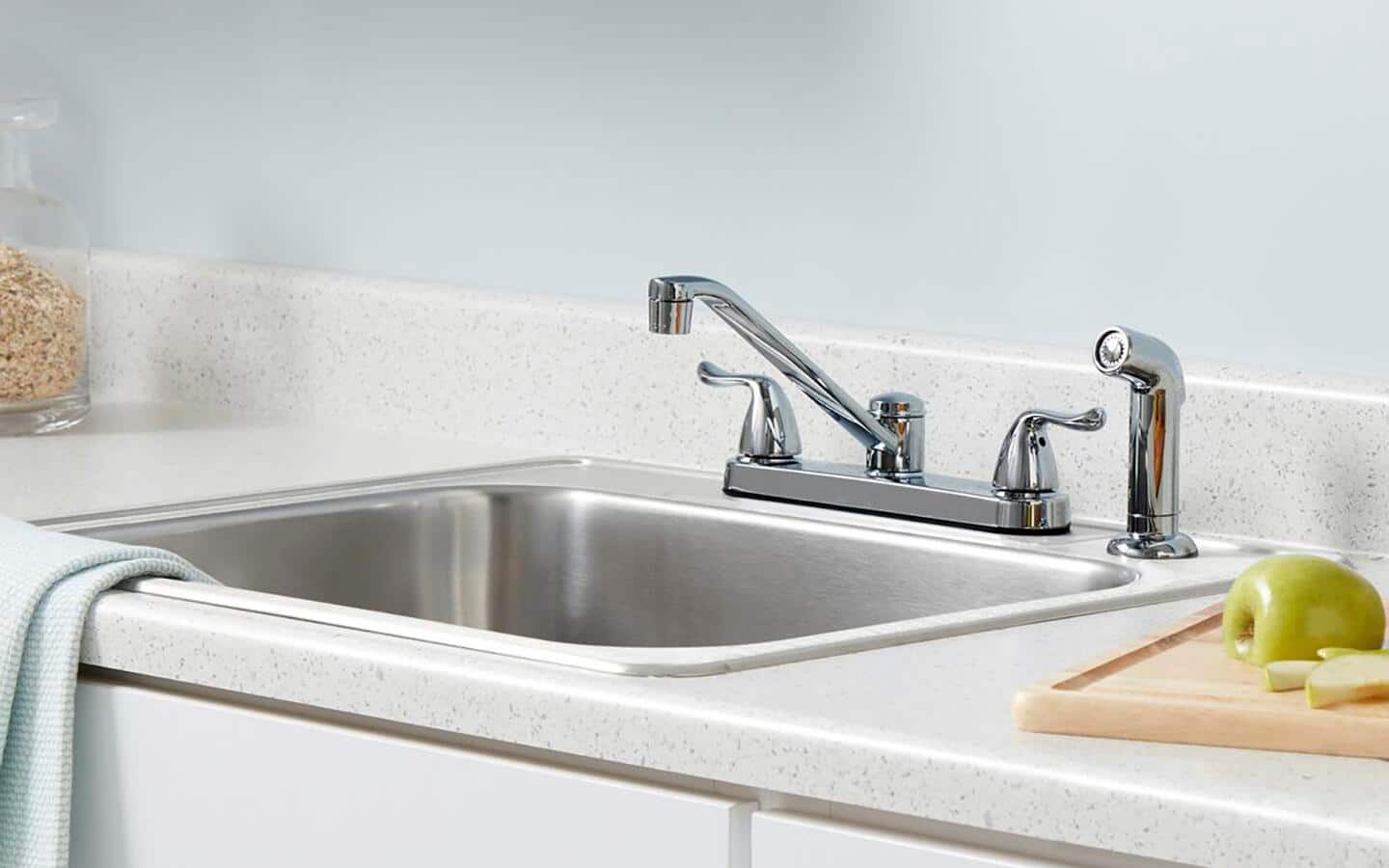 A stainless steel bar faucet and separate sprayer.
