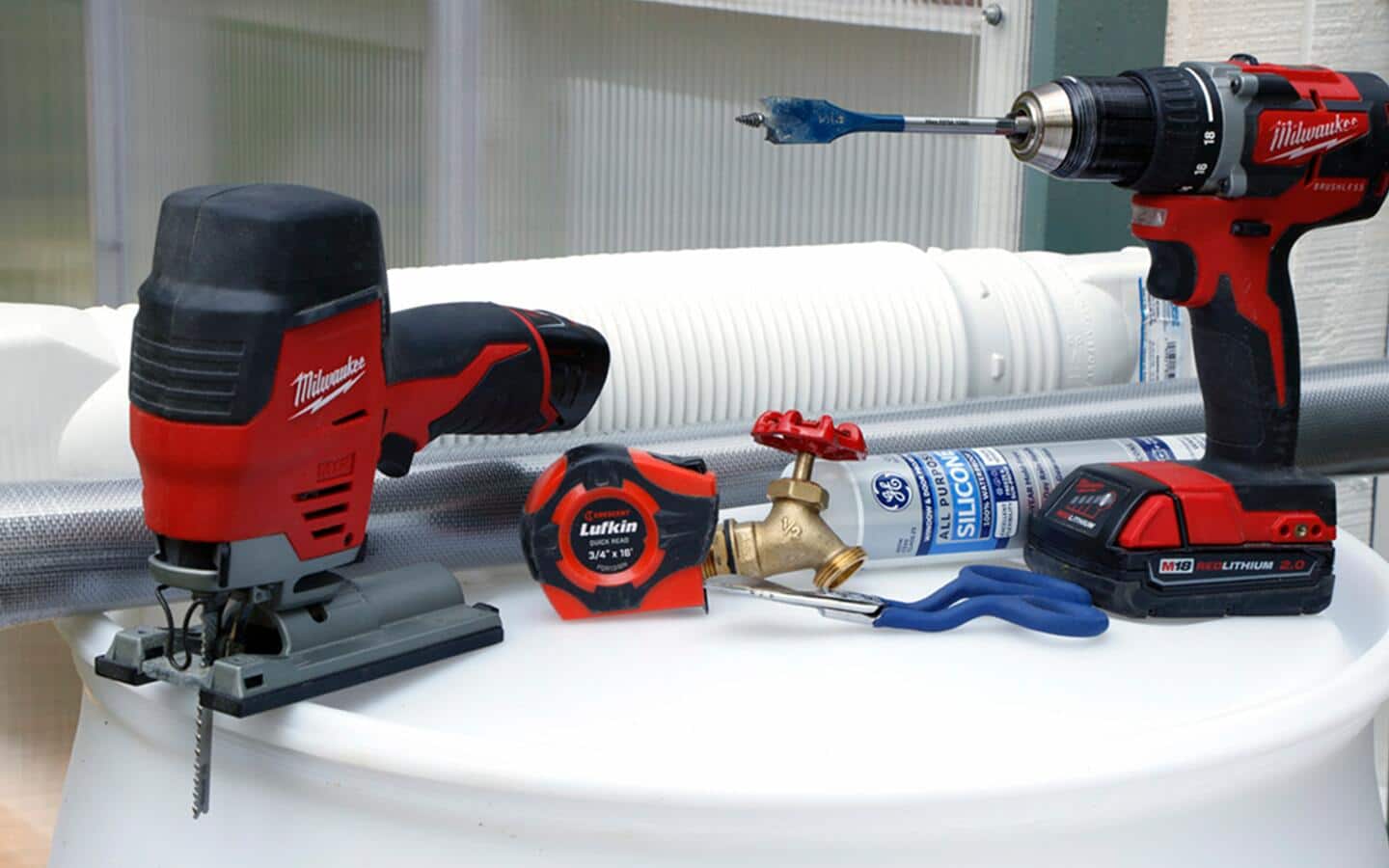 Assorted tools and materials for creating a DIY rain barrel. Assorted tools and materials for creating a DIY rain barrel.