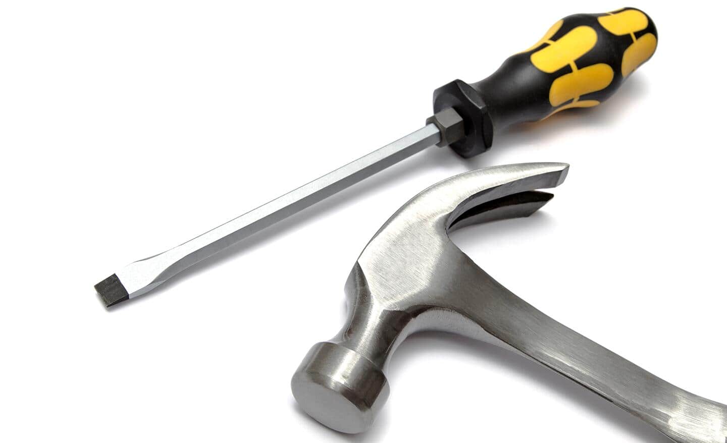 A hammer lying beside a screwdriver.