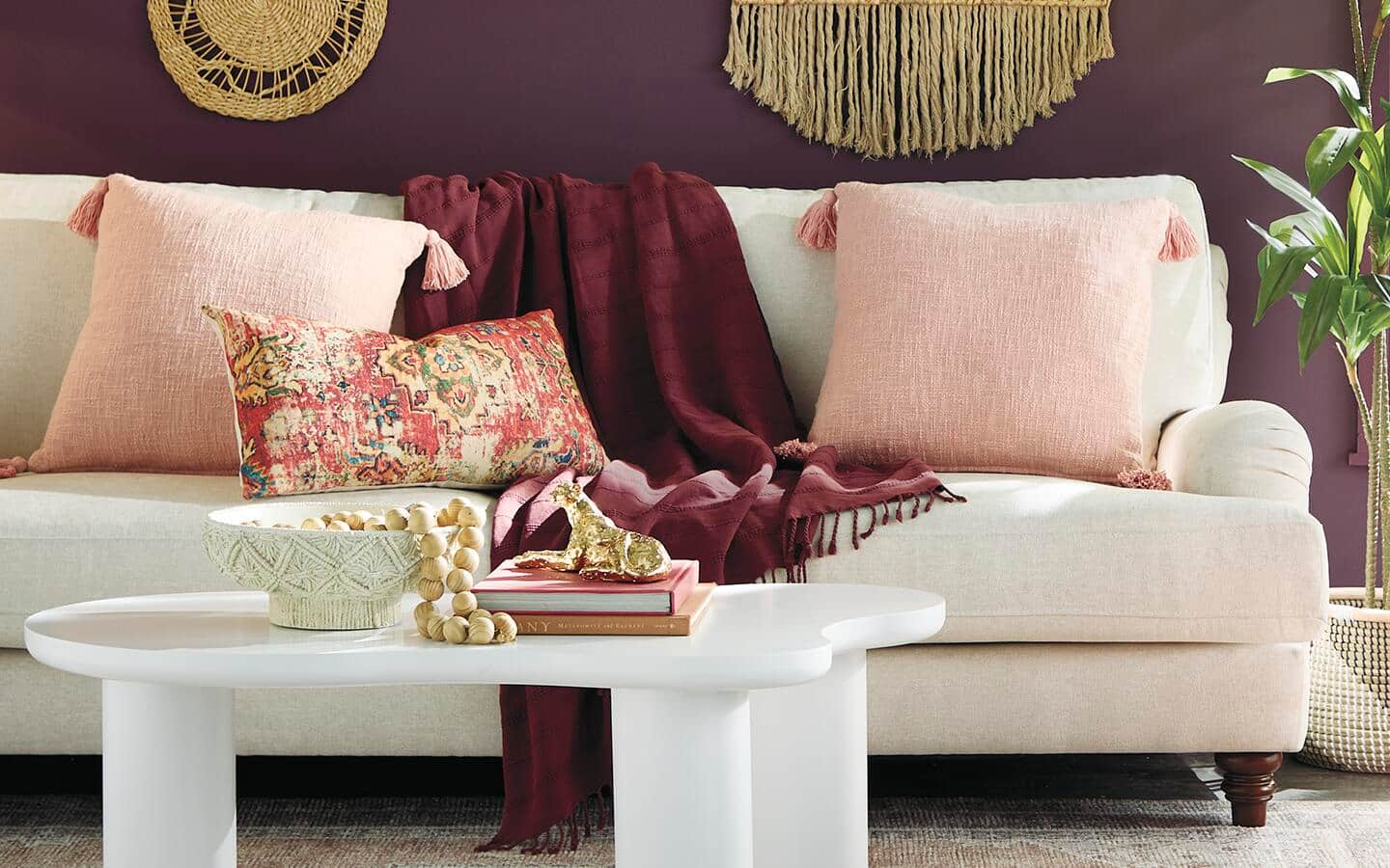 A couch filled with blankets and throws. A couch filled with blankets and throws.