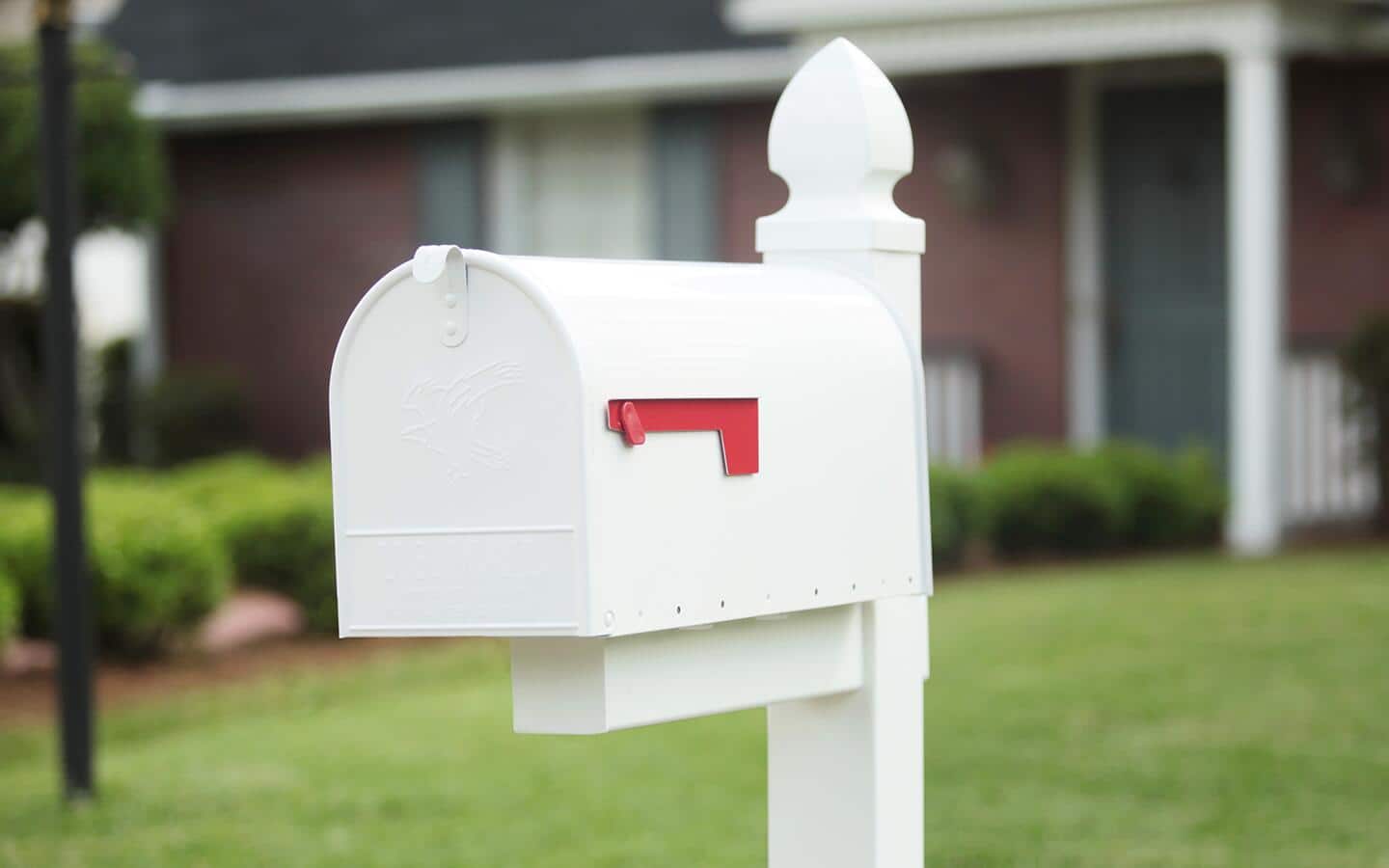 A post mailbox installed in front of a house. A post mailbox installed in front of a house.