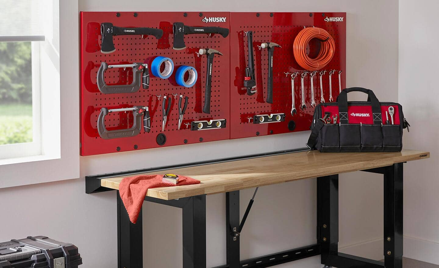 A pegboard providing vertical storage for hanging tools.