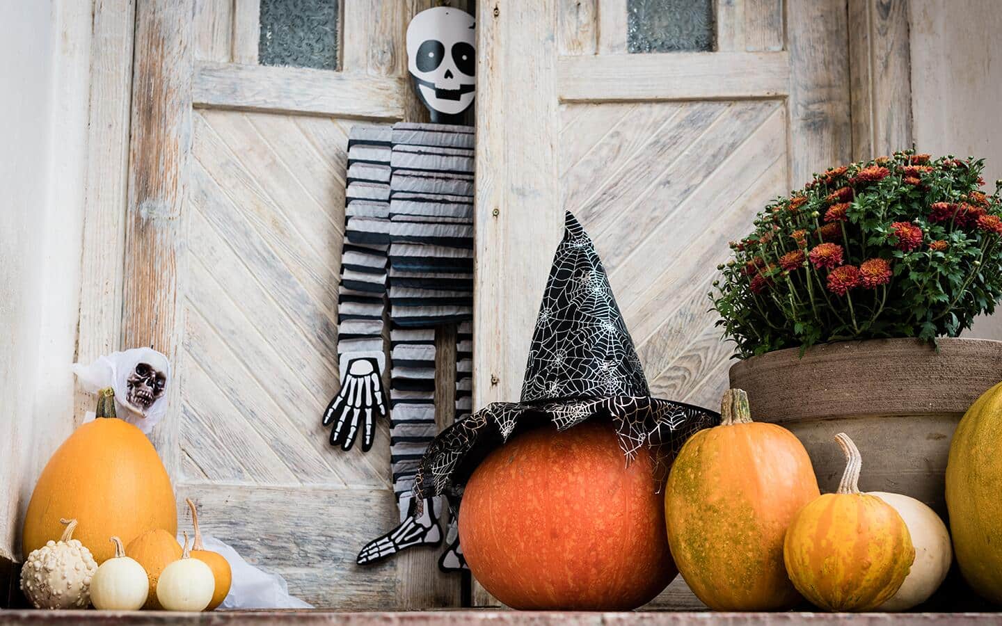 A porch decorated with pumpkins.