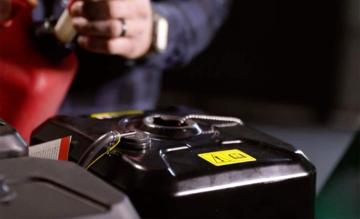 Fuel is added to a small engine.