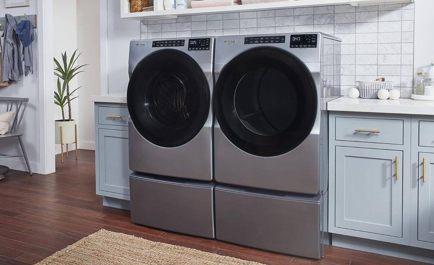 A front load washing machine and dryer installed in a kitchen.