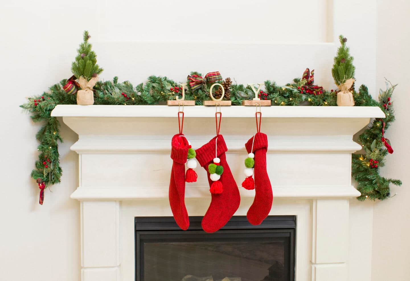 Three stockings on a fireplace.