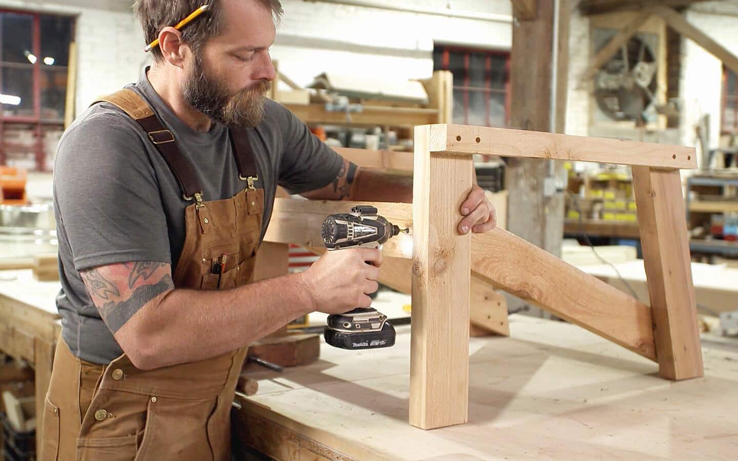 A person attaching the front apron piece of an Adirondack chair. A person attaching the front apron piece of an Adirondack chair.