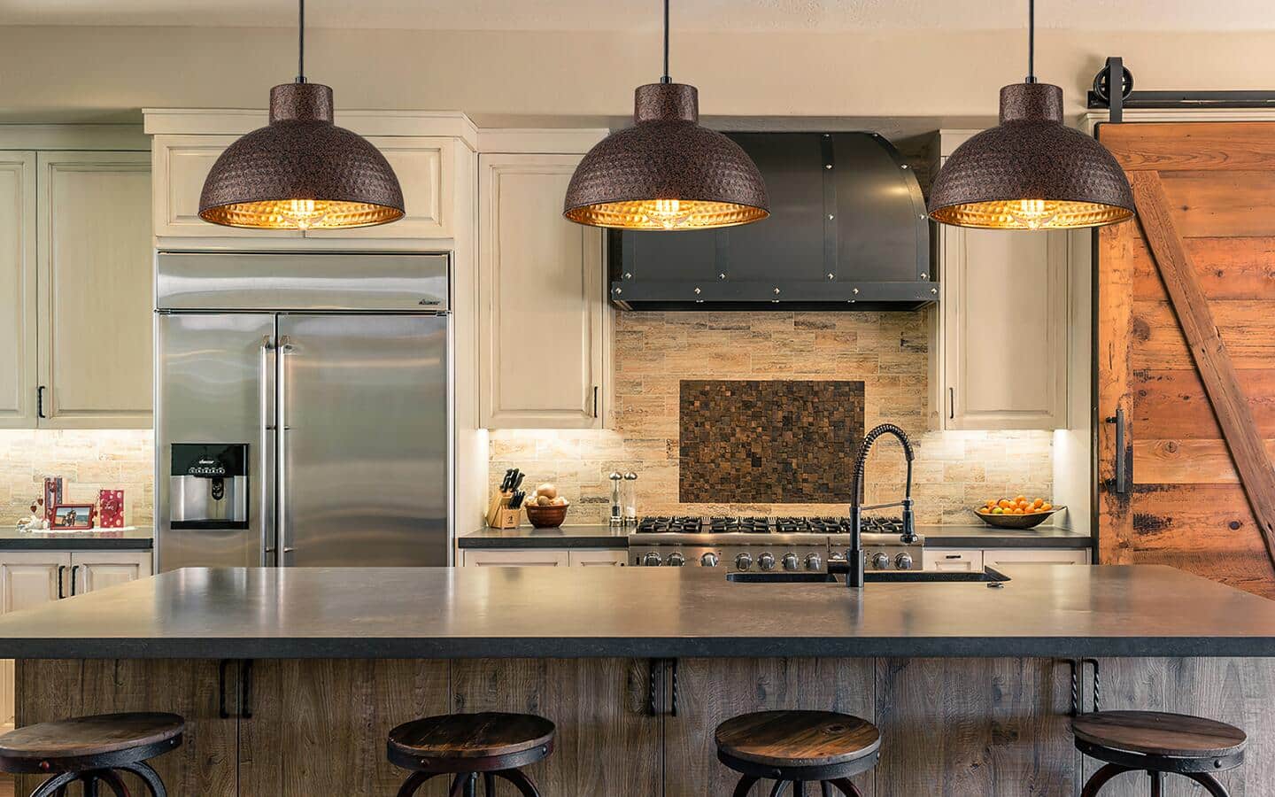 Industrial-style pendant lights hanging over a kitchen island.