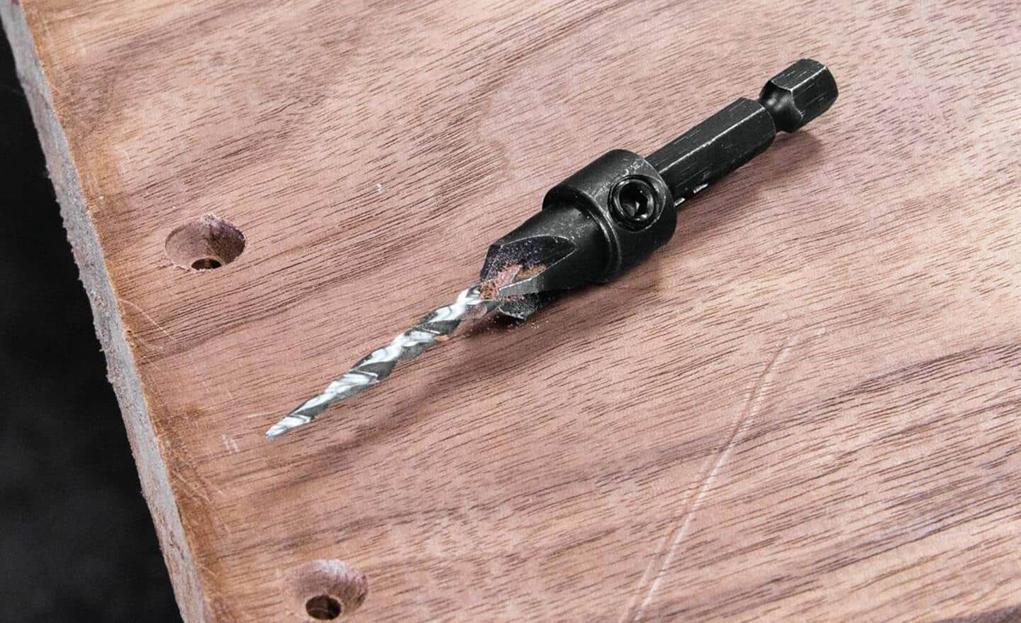 A countersink drill bit on a piece of wood.