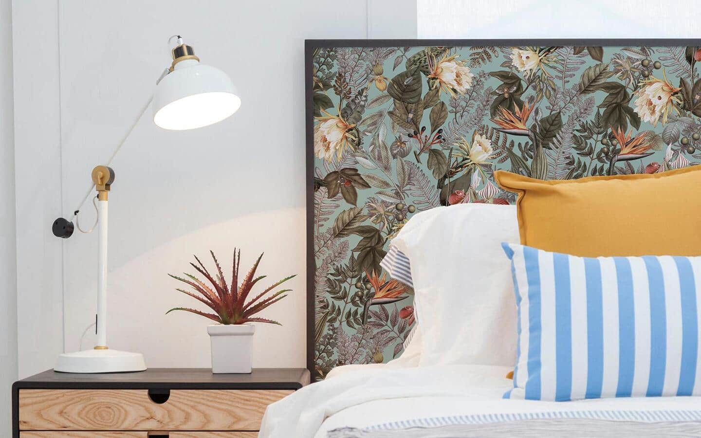 Floral motif peel and stick wallpaper adorns a simple headboard. Floral motif peel and stick wallpaper adorns a simple headboard.