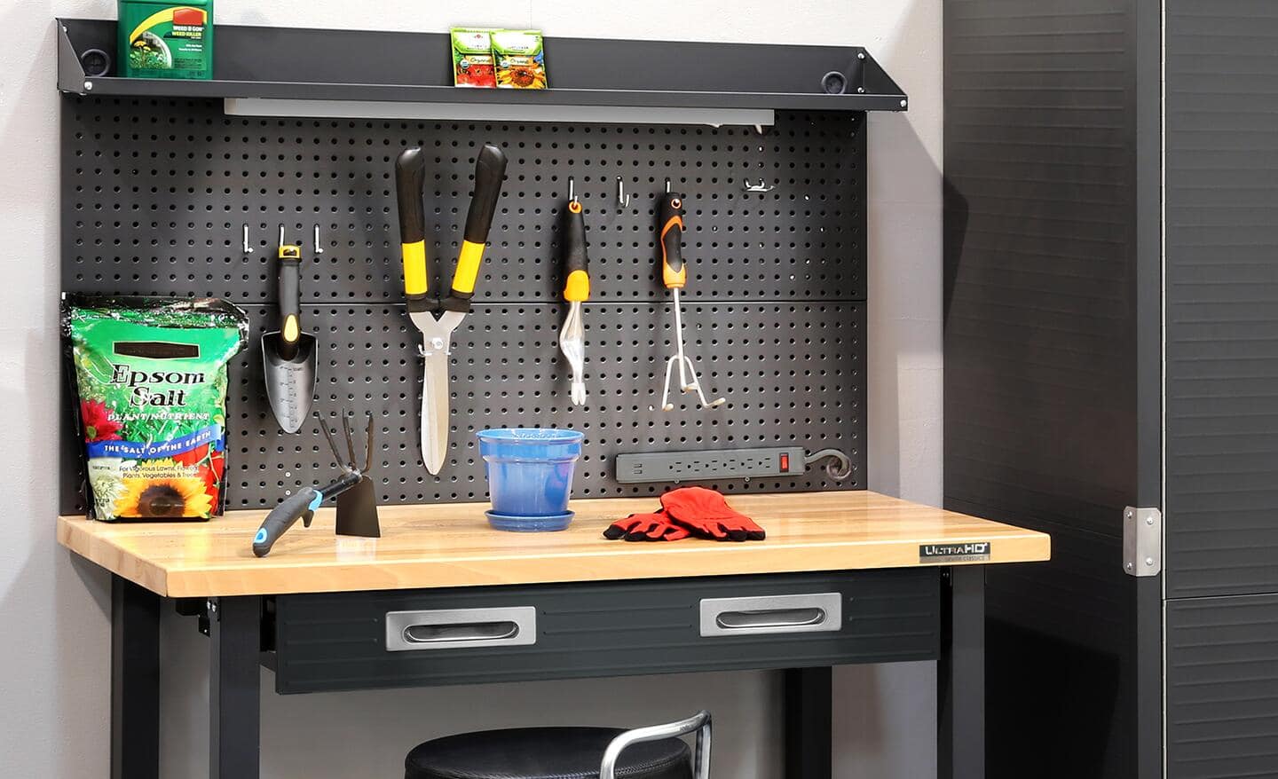 Garden hand tools stored on a pegboard in a garage