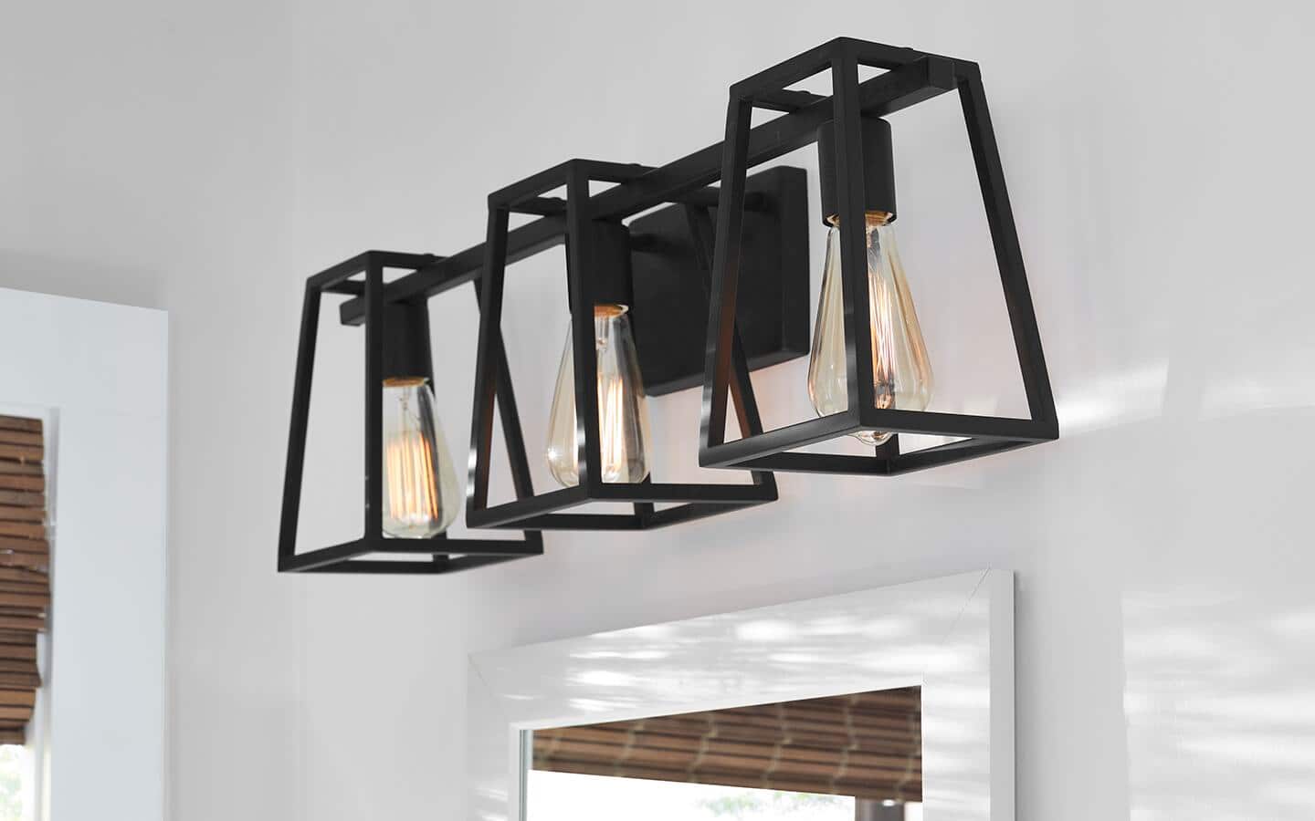 Vanity lights with a rustic metal finish installed over a white mirror. Vanity lights with a rustic metal finish installed over a white mirror.