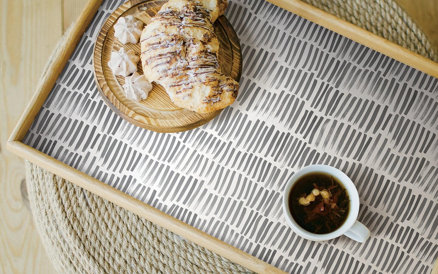 A serving tray bottom refreshed with a graphic patterned, peel and stick wallpaper. A serving tray bottom refreshed with a graphic patterned, peel and stick wallpaper.