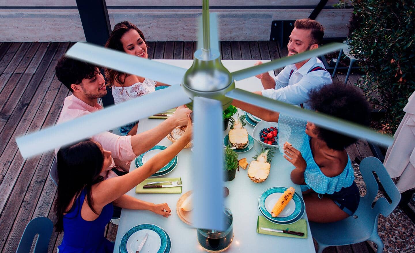 A family dining under a chrome ceiling fan.