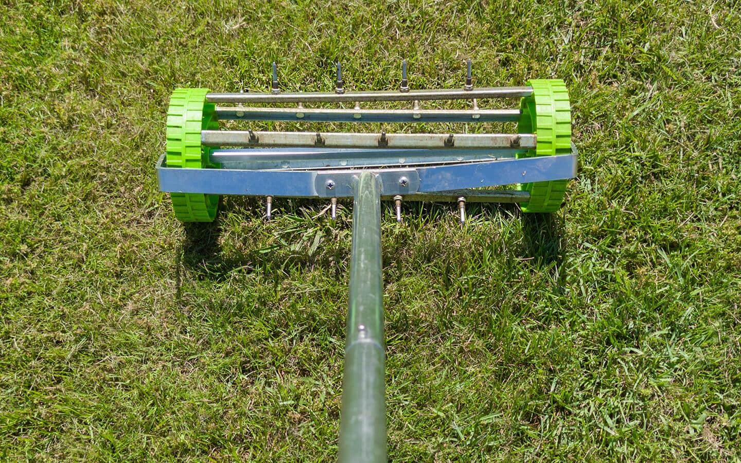 An aerator resting on an overgrown lawn. An aerator resting on an overgrown lawn.