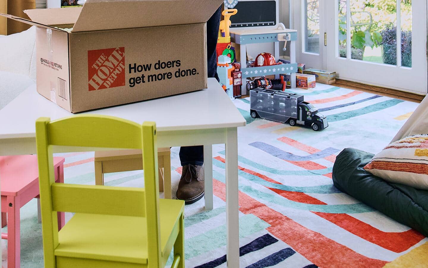 A playroom with a colorful rug on the floor.