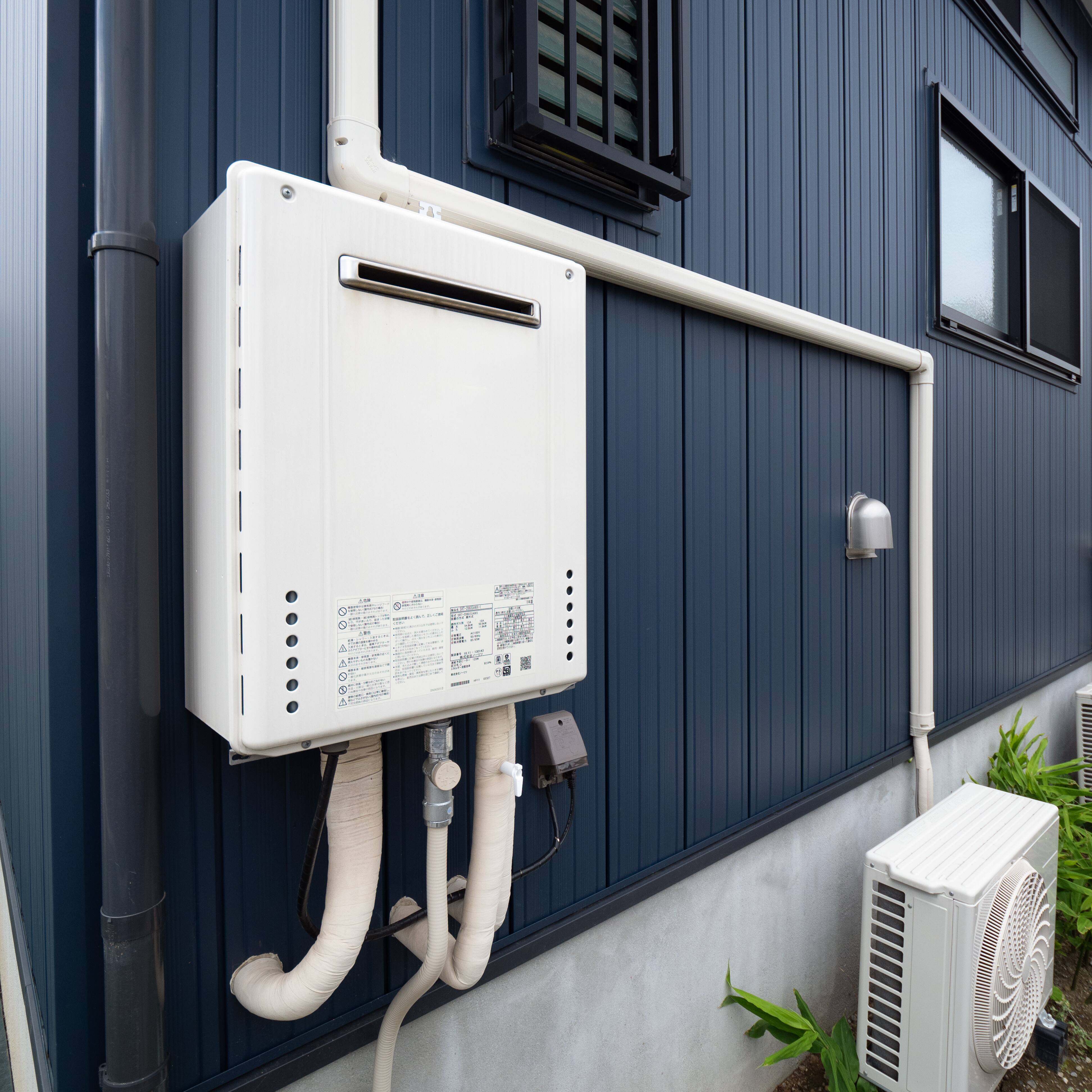 A tankless water heater installed outside a home.