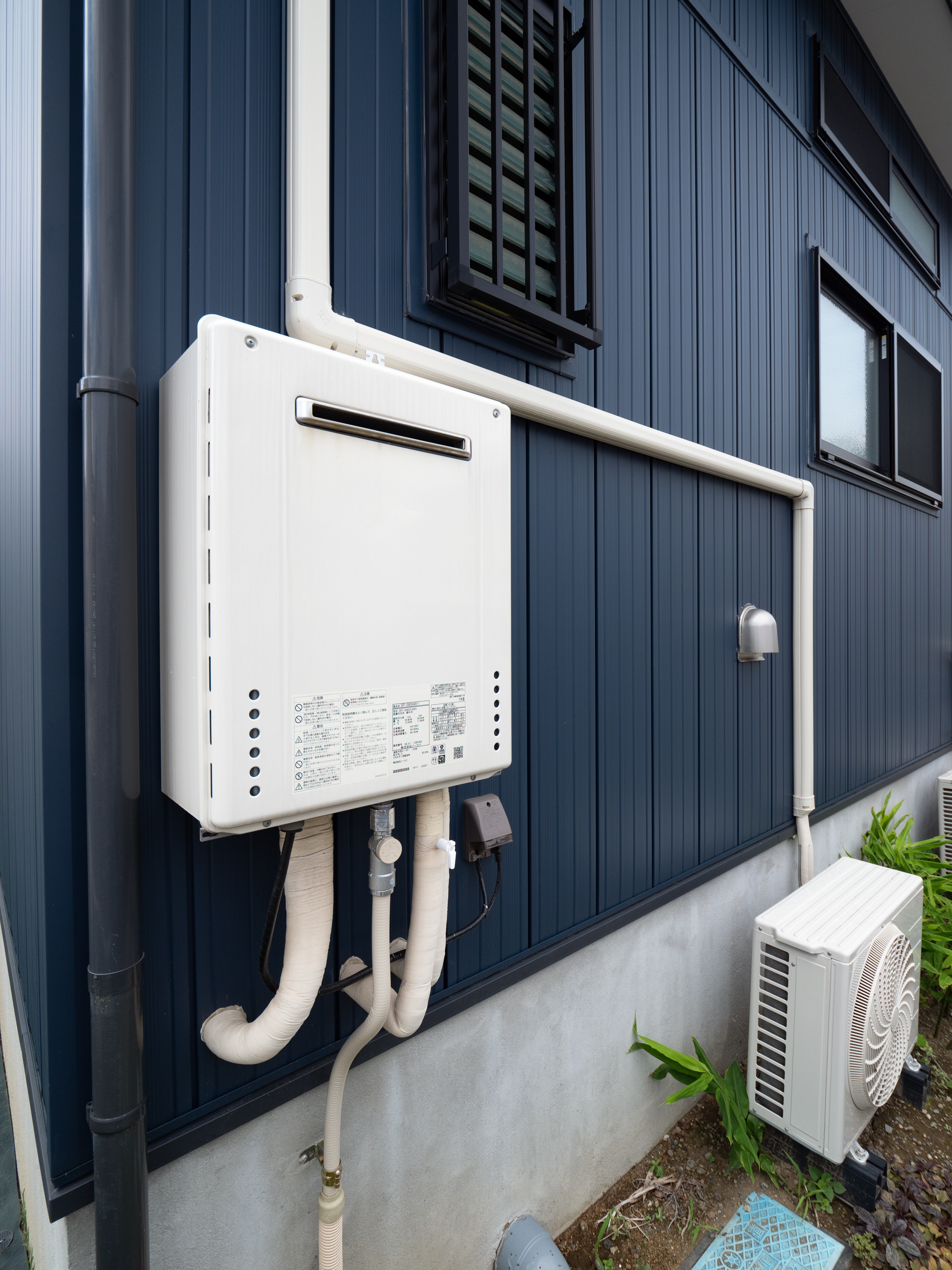 A tankless water heater installed outside a home.