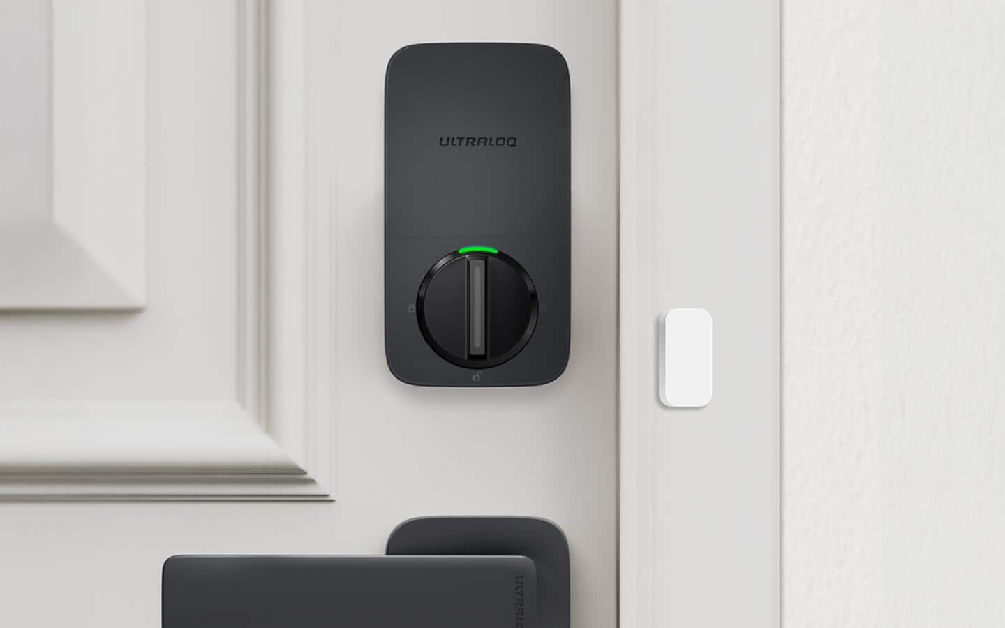 A smart deadbolt lock installed in a closed front door. A smart deadbolt lock installed in a closed front door.