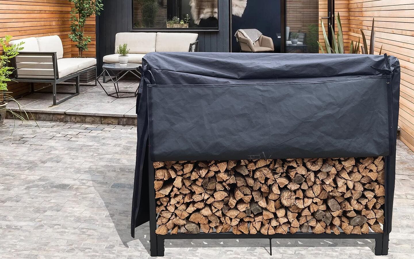Logs stacked in a firewood rack with a cover