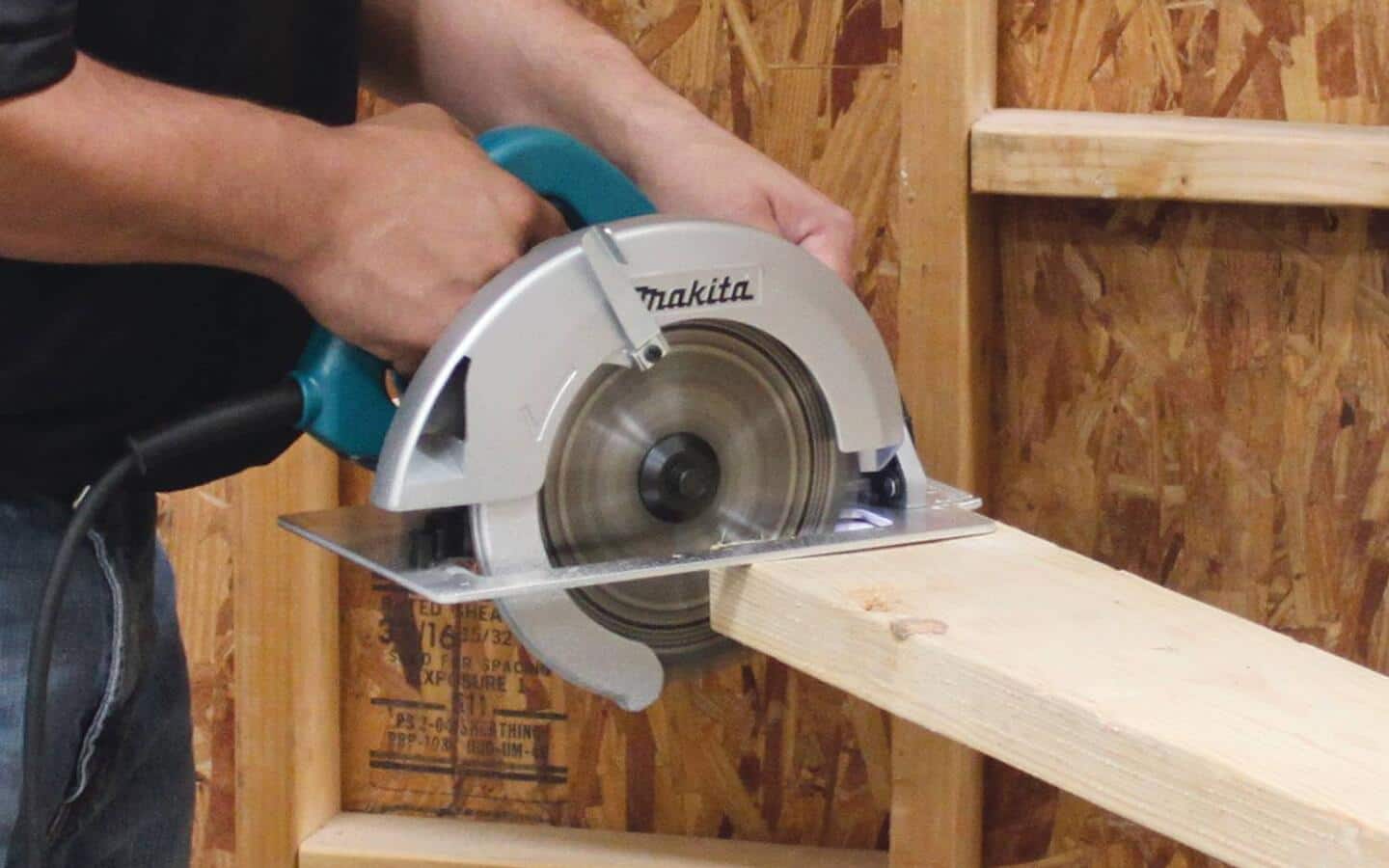 A person cuts a stud with a circular saw.  A person cuts a stud with a circular saw.