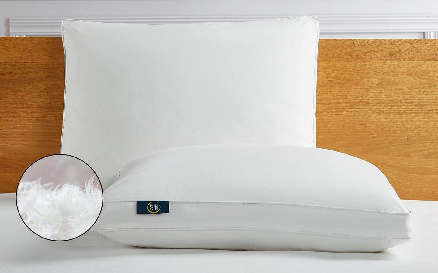 A down pillow placed on a bed. A down pillow placed on a bed.