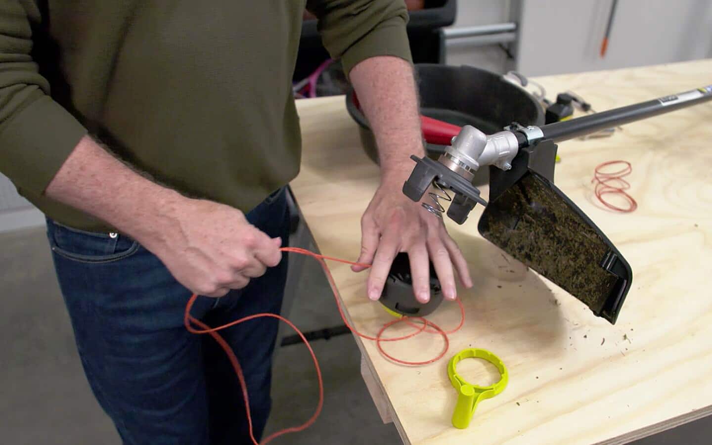 Someone pulling on the string in a string trimmer. 