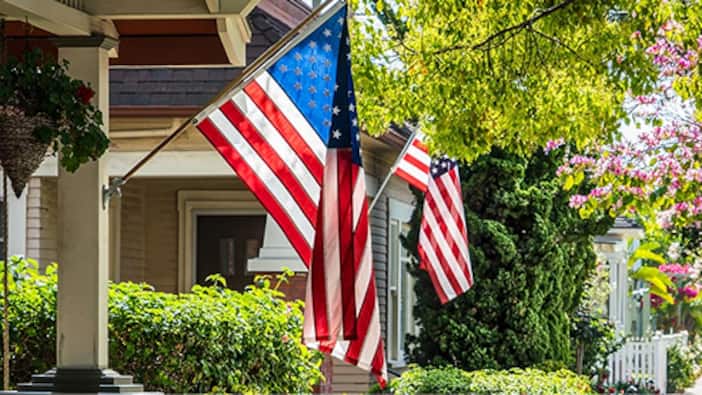 American flag hanging on front porch post