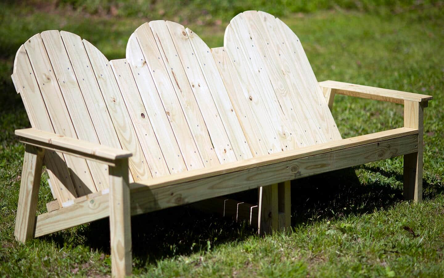 An outdoor wooden sofa.