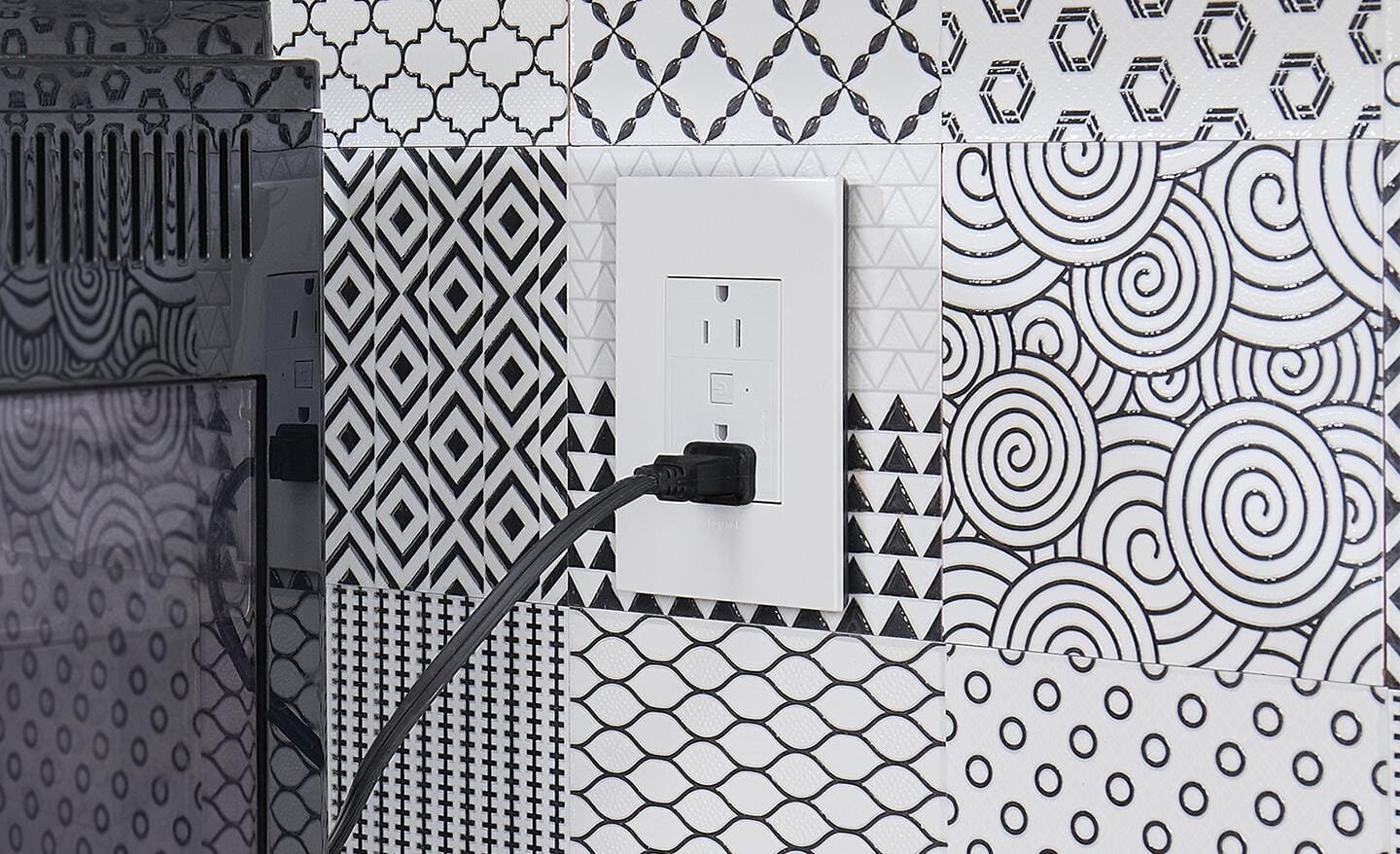 A smart outlet installed on a wall in a bath.