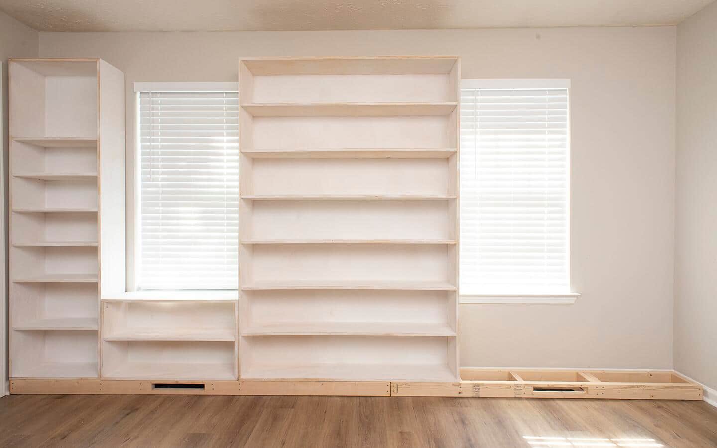 The third part of a built in shelving unit is installed.