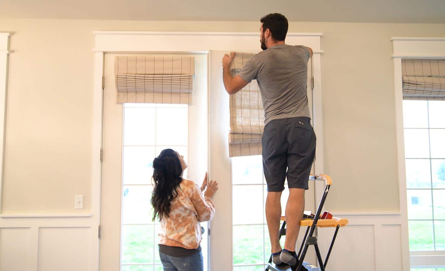 Homeowners install shades over their windows Homeowners install shades over their windows