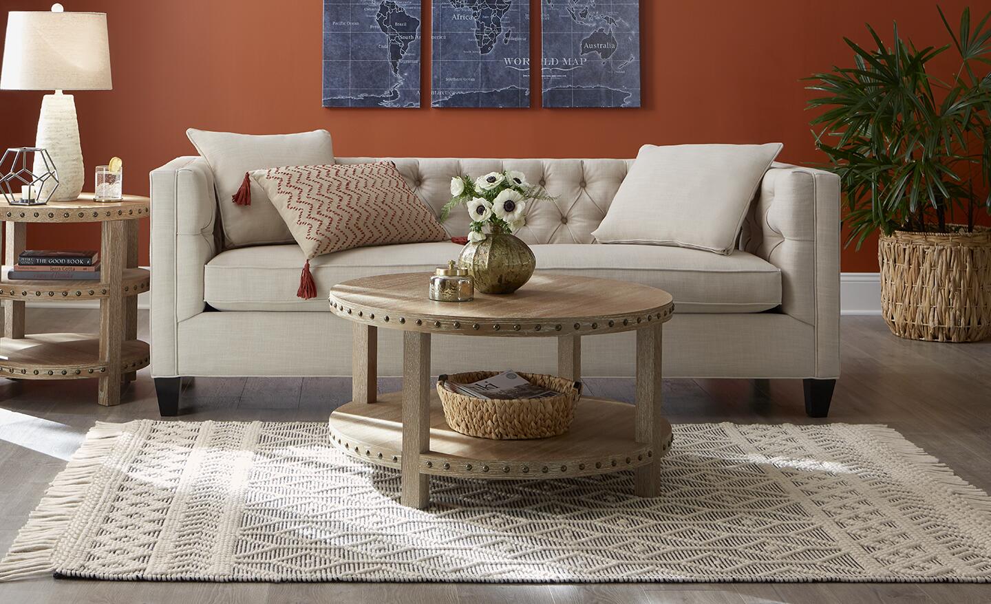A wool area rug in front of an eggshell-colored sofa in a living room. A wool area rug in front of an eggshell-colored sofa in a living room.