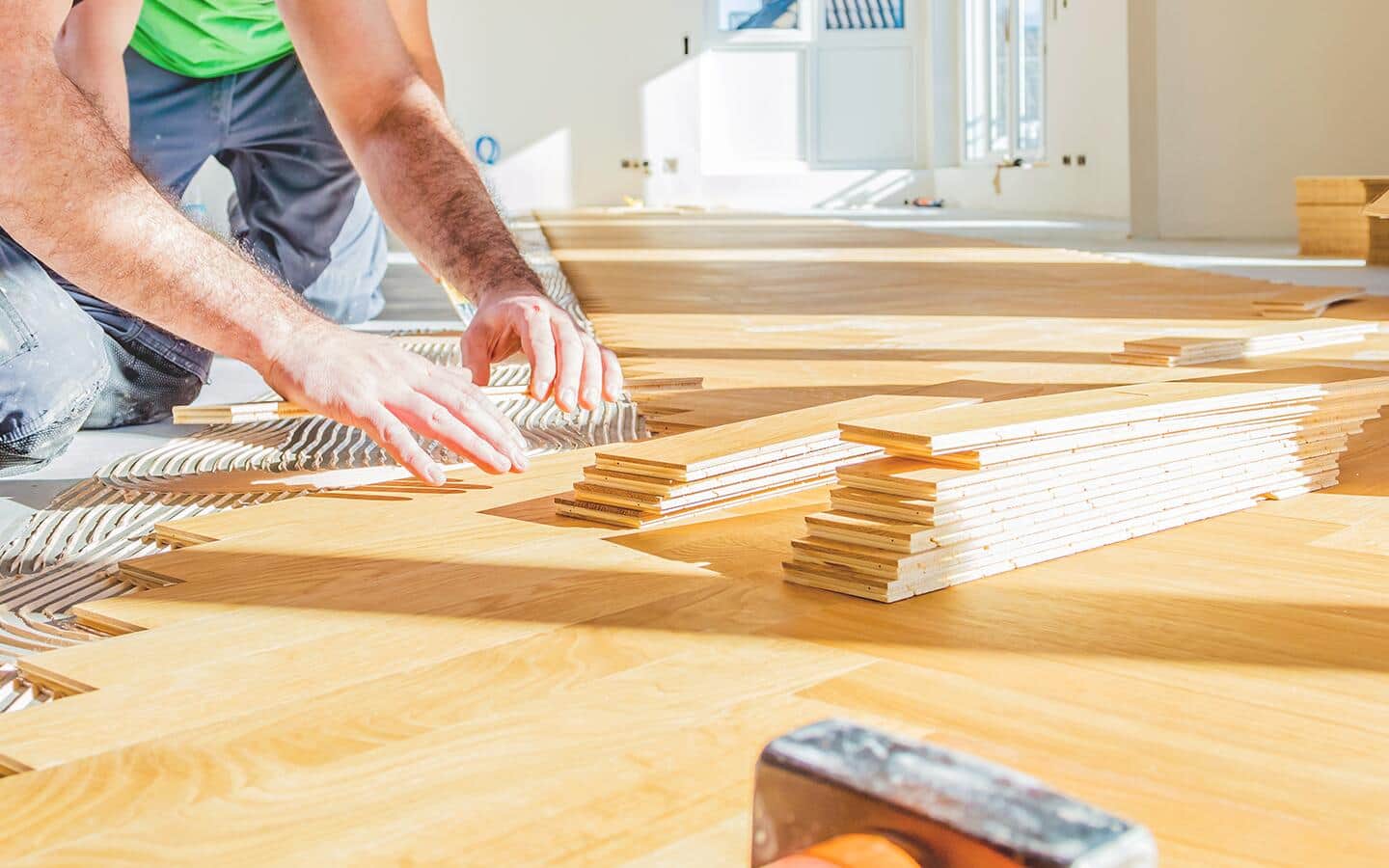 A person lays out tiles to acclimate in a room. A person lays out tiles to acclimate in a room.