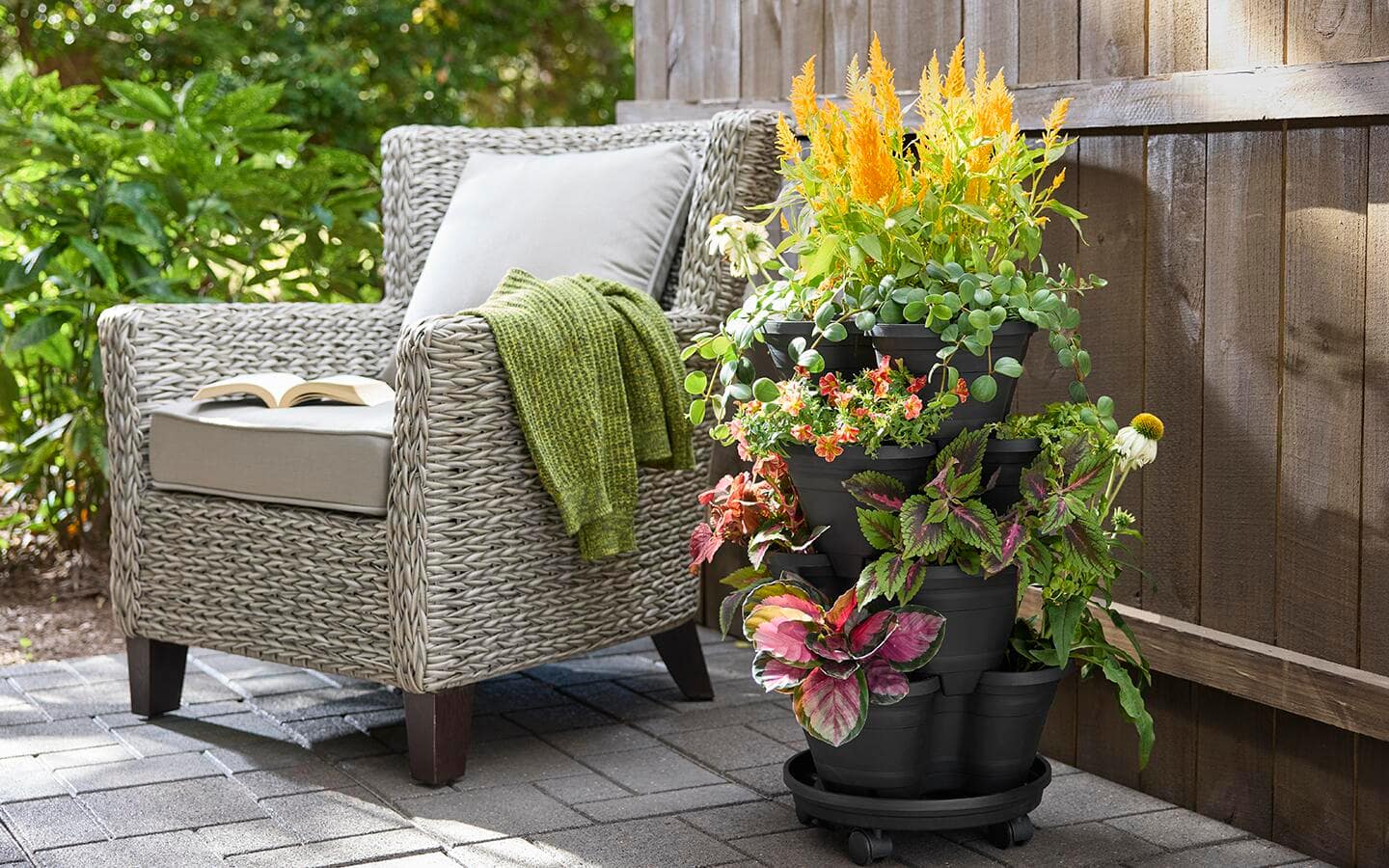 Different plants in a planter on a patio, using drip irrigation.