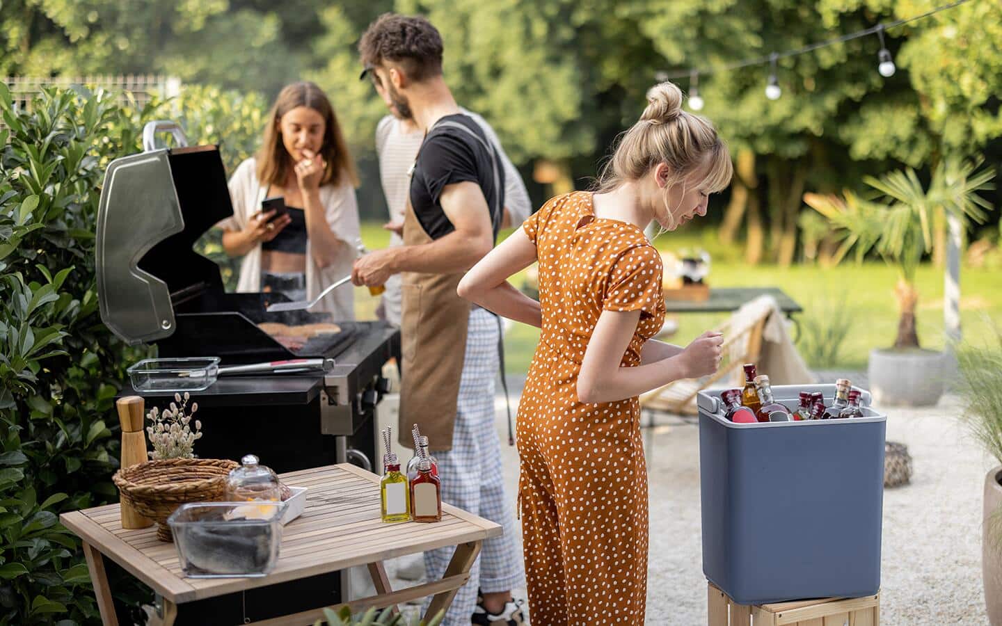 Friends gathered outdoors for a barbeque party. Friends gathered outdoors for a barbeque party.