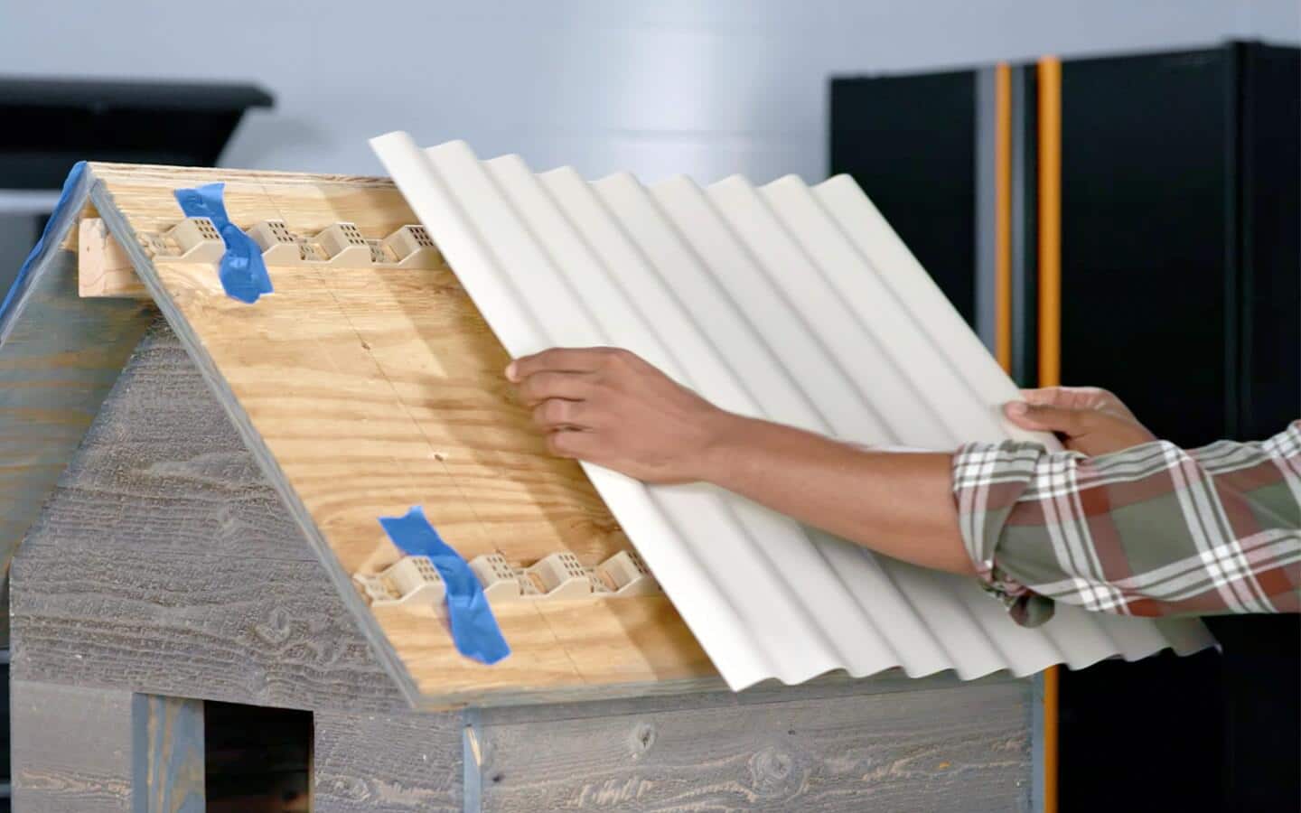 White plastic being installed to serve as roof covering.