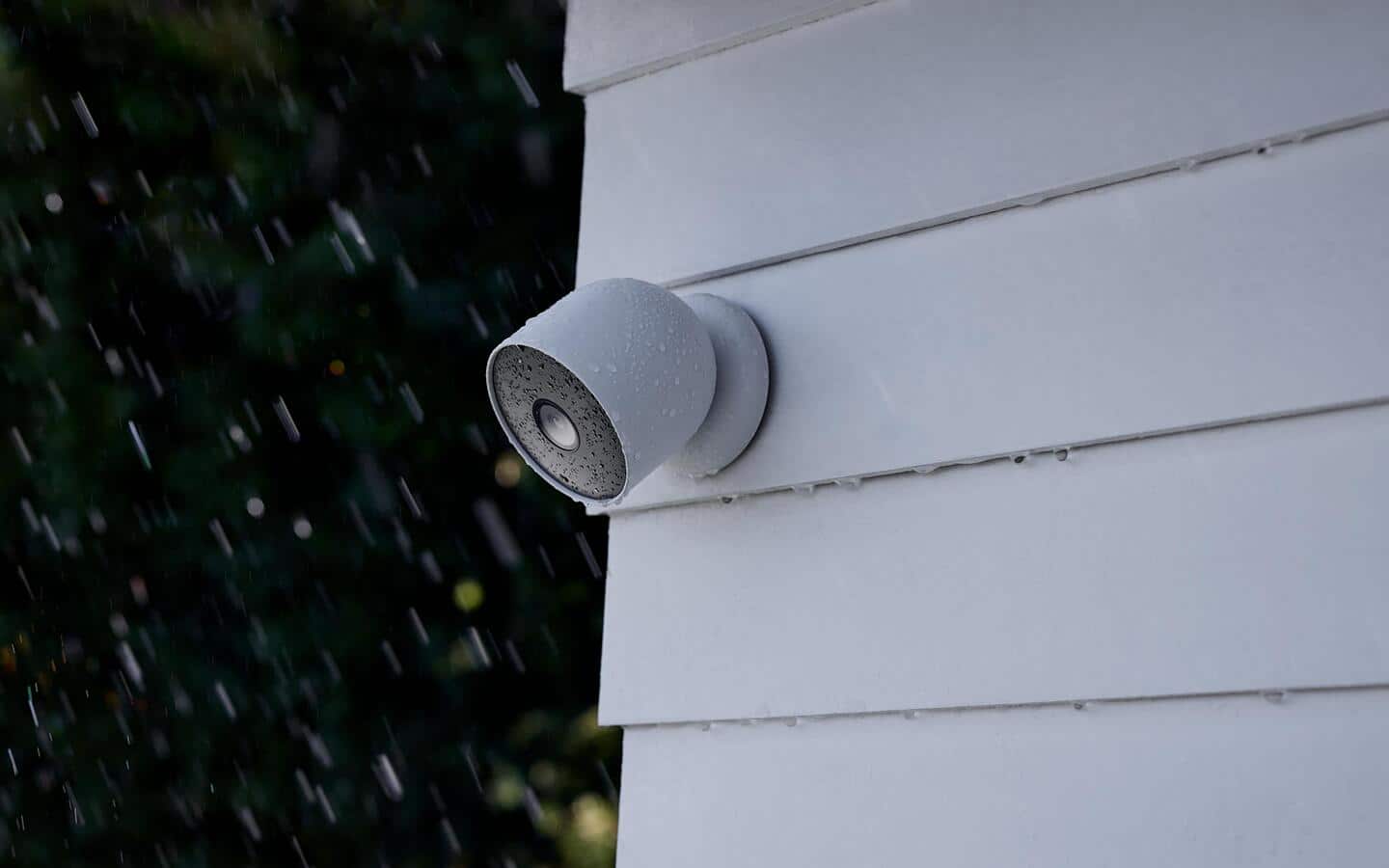 A home security camera attached to an outside wall.