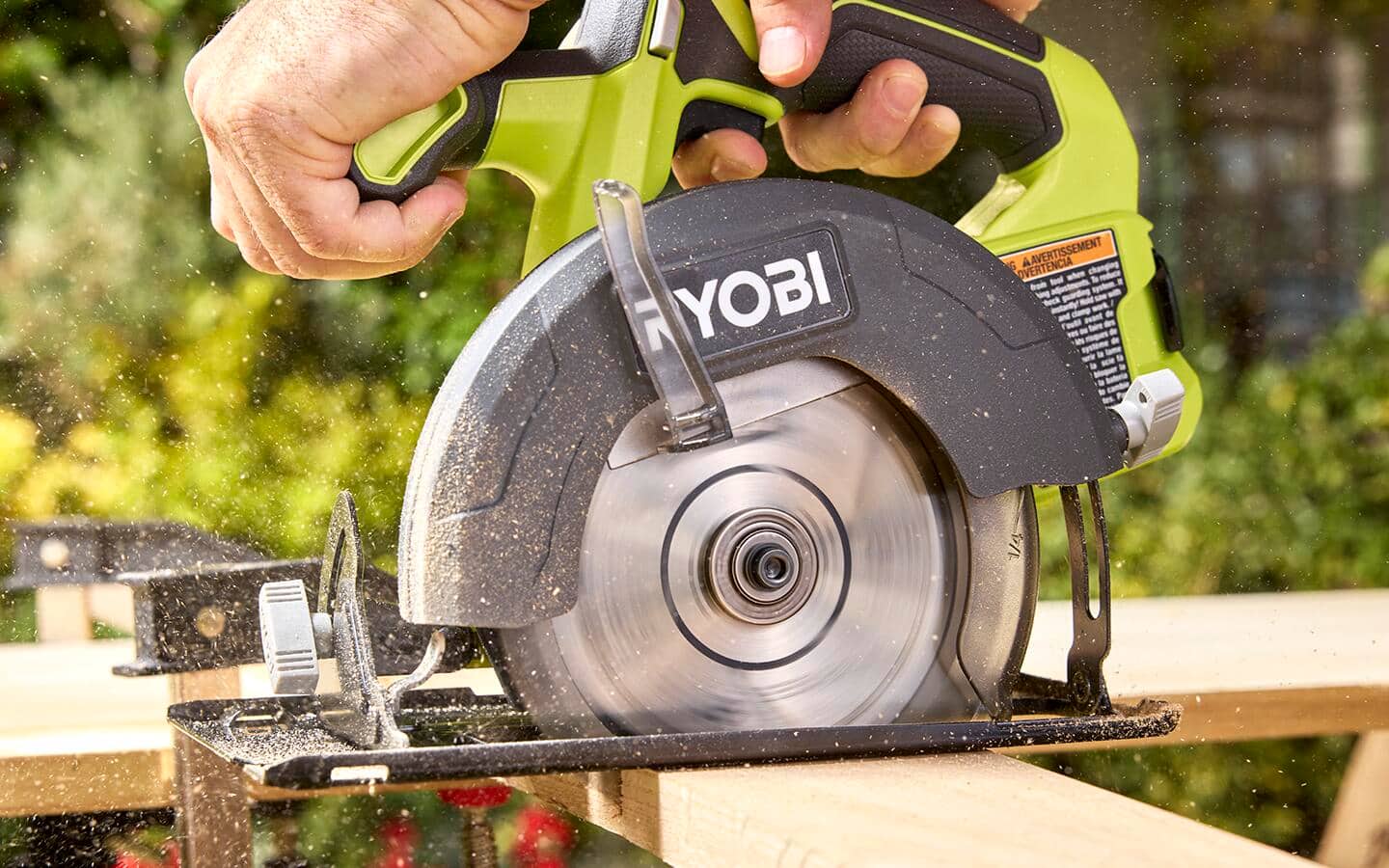 A miter saw being used to cut lumber for shelving.