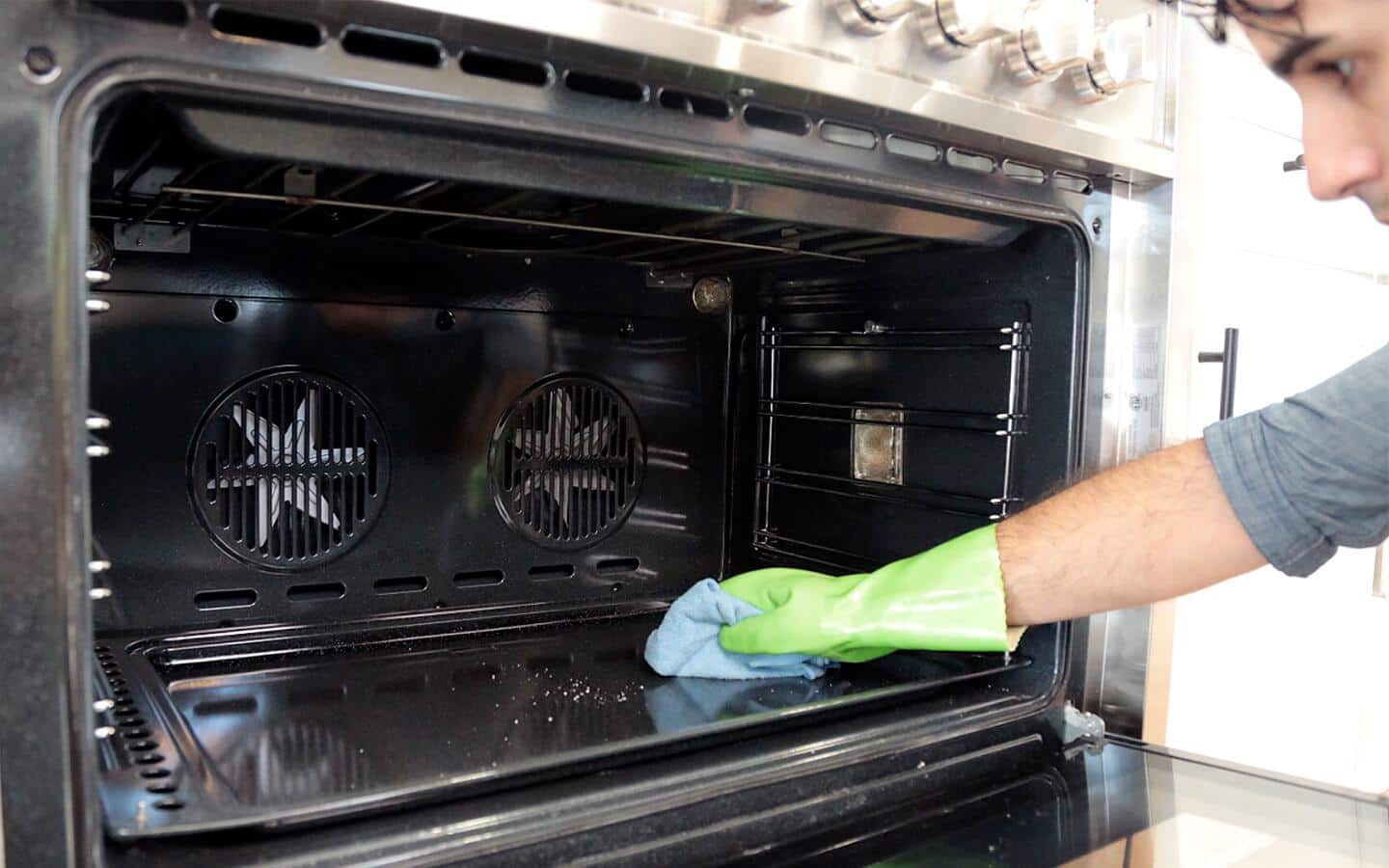 Someone cleaning inside oven. Someone cleaning inside oven.