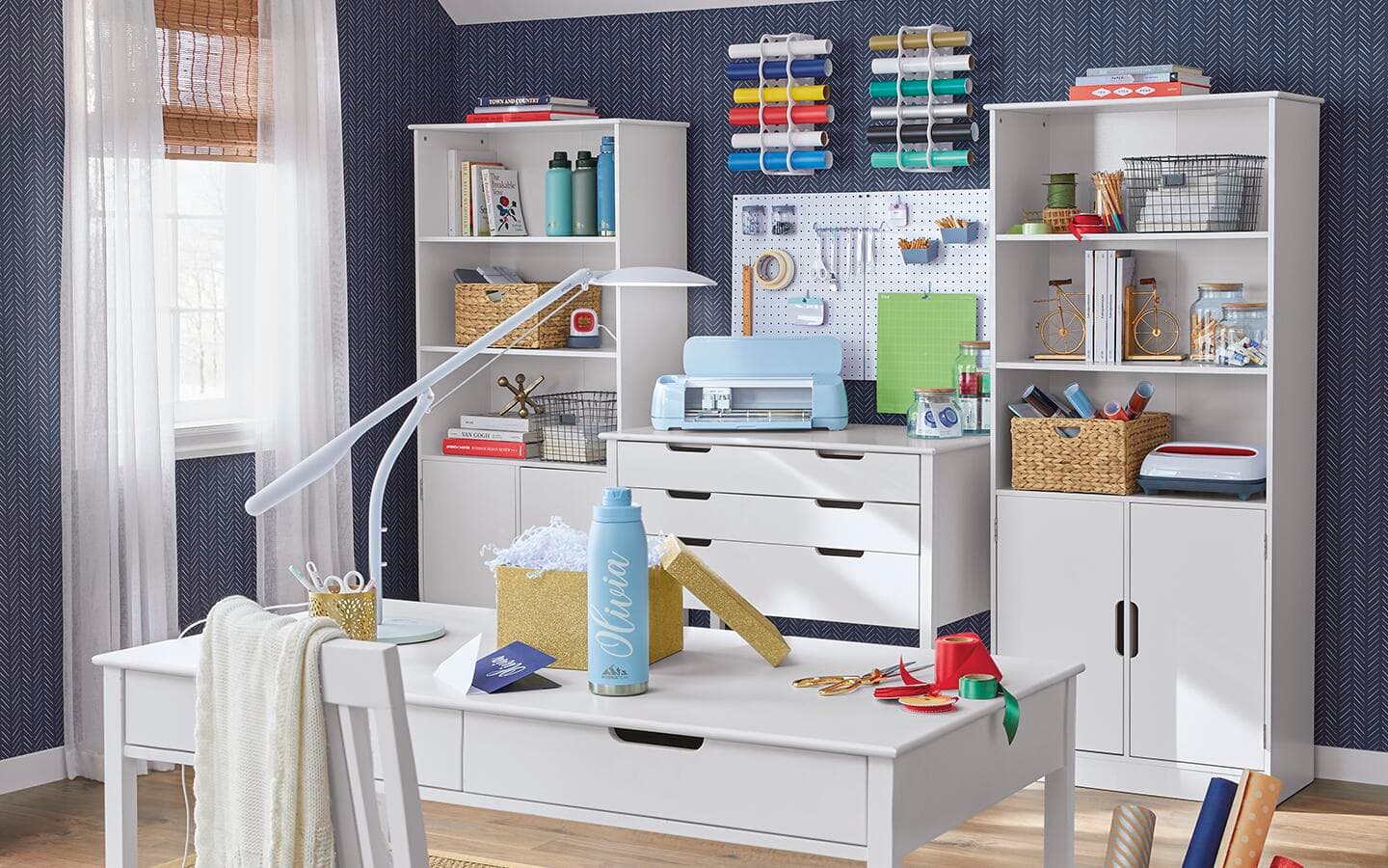 Super organized craft room with desk, cabinet and bookcases Super organized craft room with desk, cabinet and bookcases