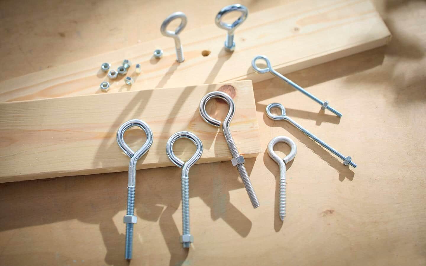 A grouping of eye bolts with nuts and washers.