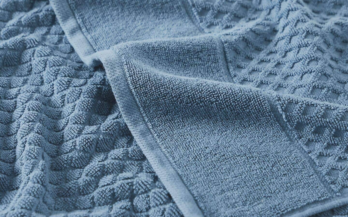 A close-up look at a light-blue bath towel.  A close-up look at a light-blue bath towel.