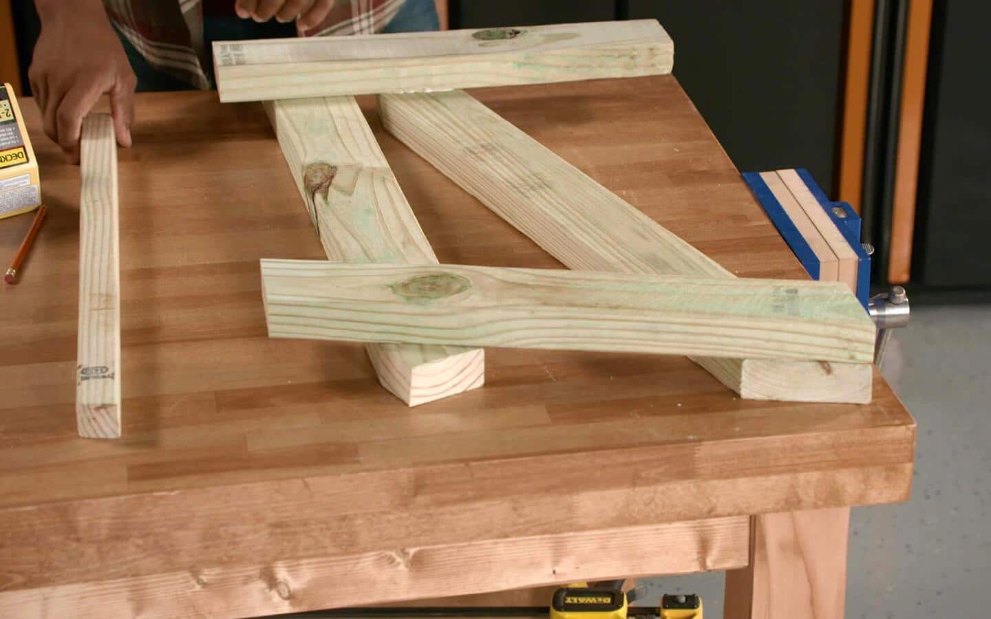 An outdoor sofa's future legs being partnered with its arm supports. An outdoor sofa's future legs being partnered with its arm supports.