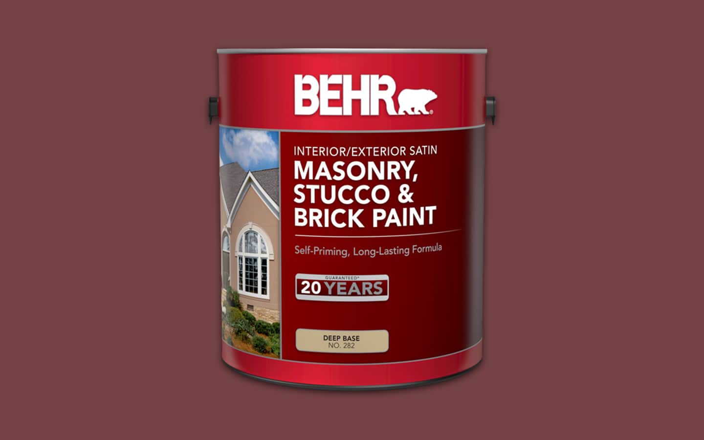 A can of masonry, stucco and brick paint placed in front of a wall.