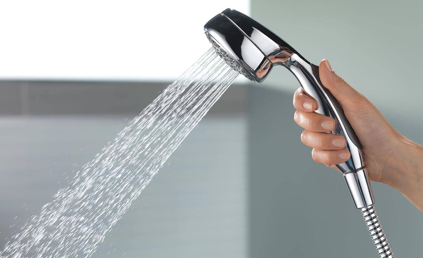 Someone holding a hand-held shower.