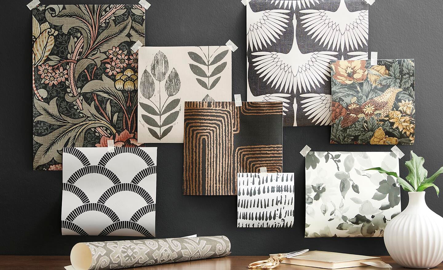 Several peel and stick wallpaper patterns displayed on a wall.