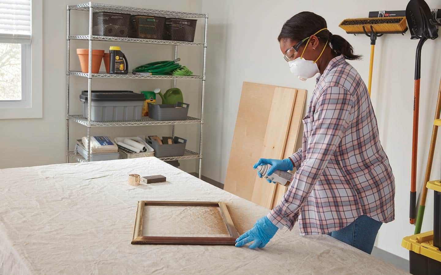 A person spray paints a frame. A person spray paints a frame.