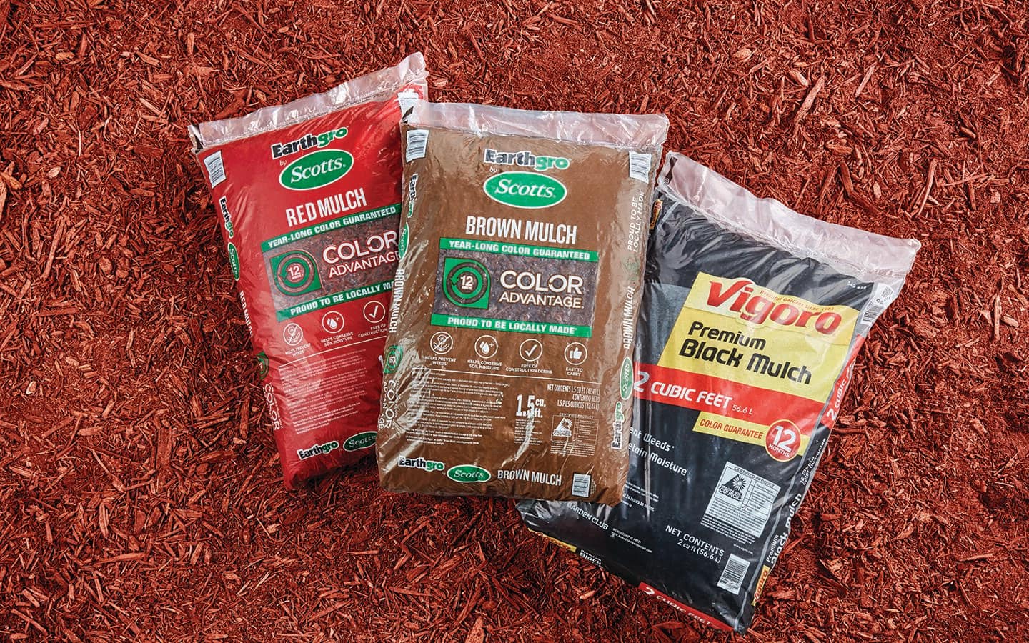 Bags of red, brown and black mulch on a field of red mulch. Bags of red, brown and black mulch on a field of red mulch.